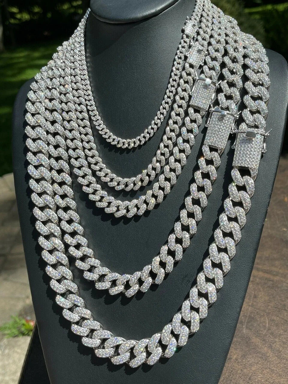 Classic iced out Cuban link chains in multiple widths on display