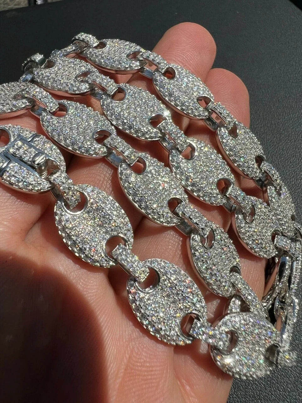 Macro detail of the stone-set Gucci links and clasp