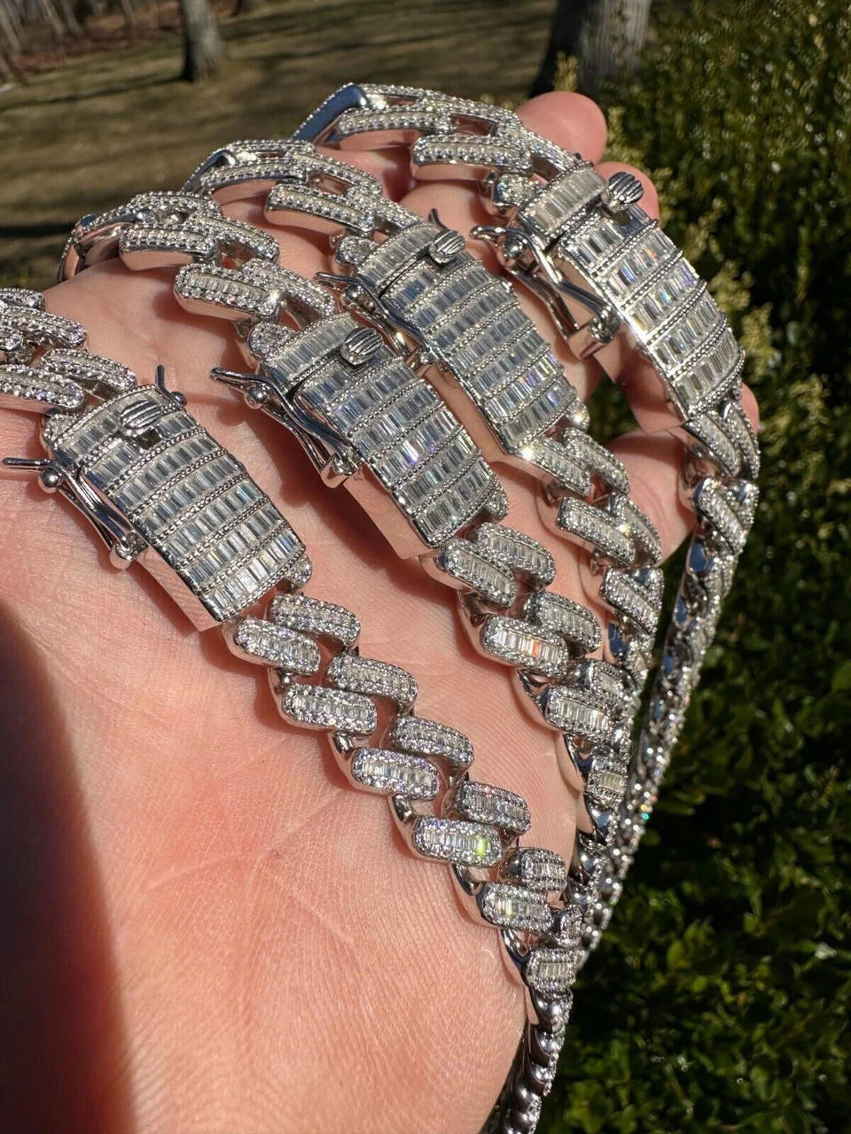 Close up of iced out Cuban link chain clasp with baguette stones