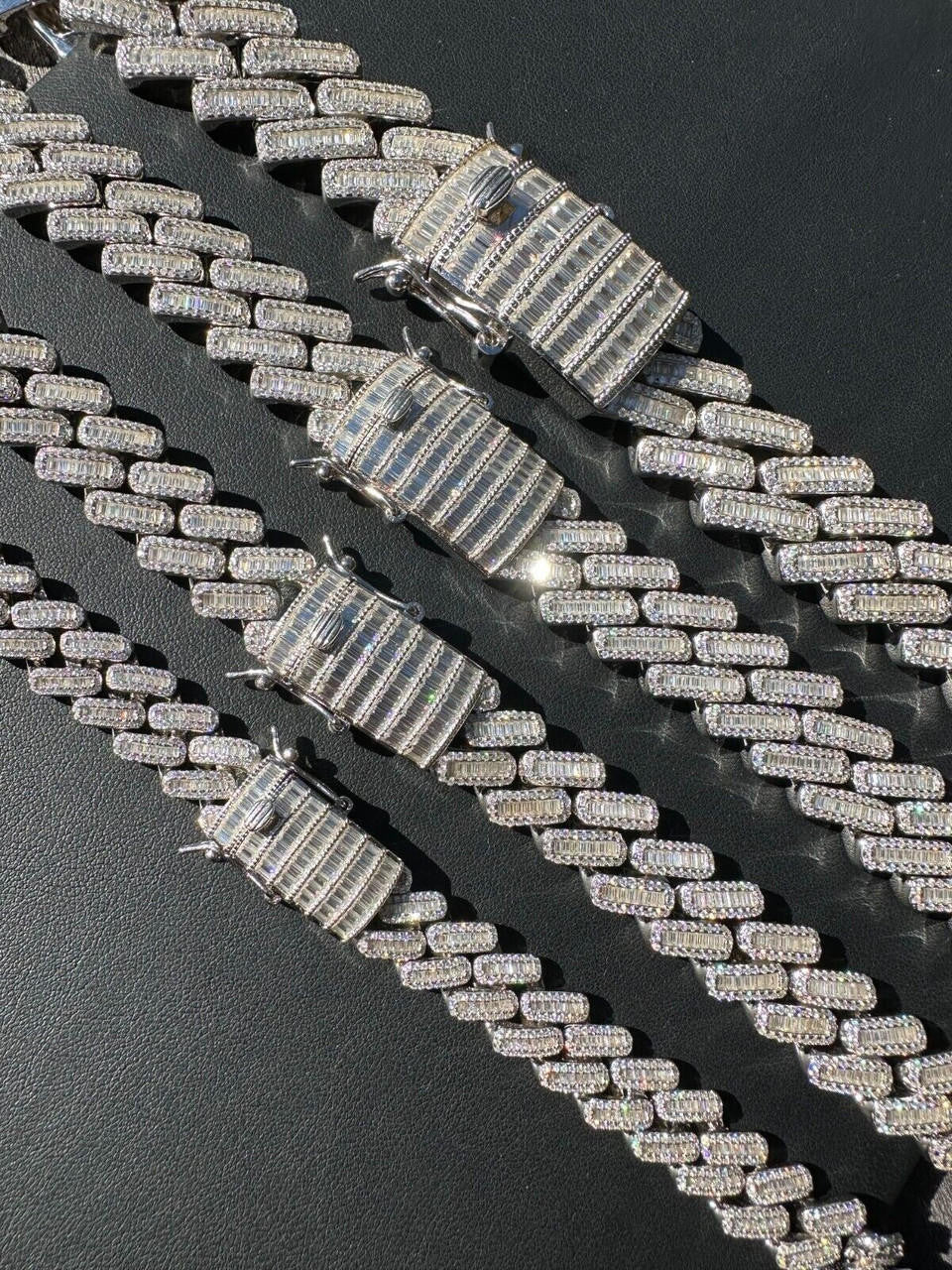 Detailed view of iced out Cuban link chain with baguette stones