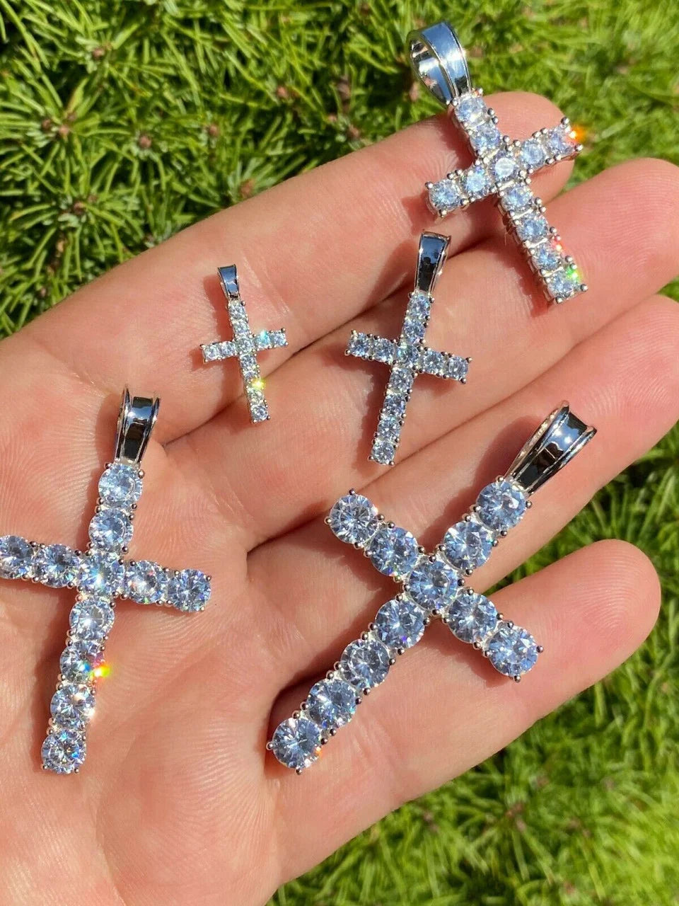 Iced out Jesus cross pendants shown in natural light